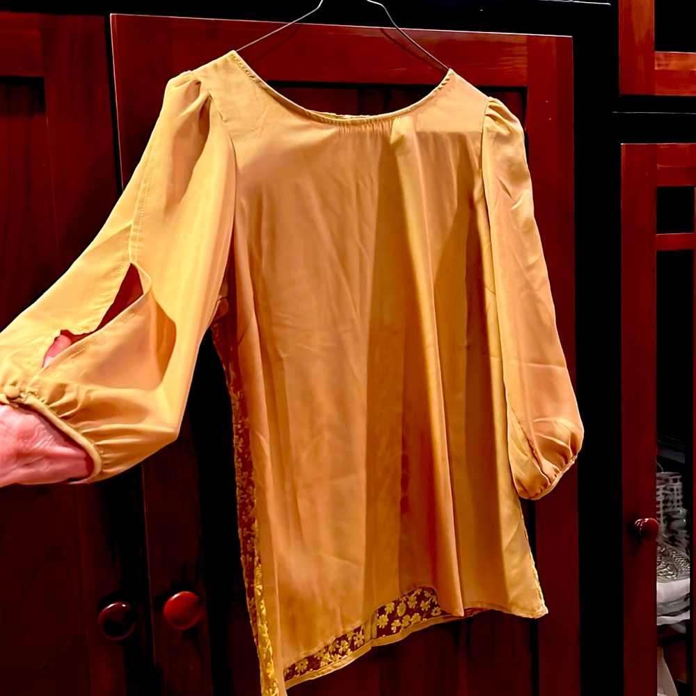 Timing brand gold split sleeve blouse with covered buttons, lace back.